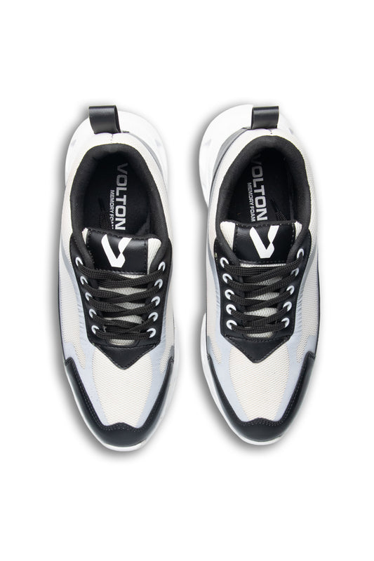 White and black sneakers with 'Volution' branding on a white background