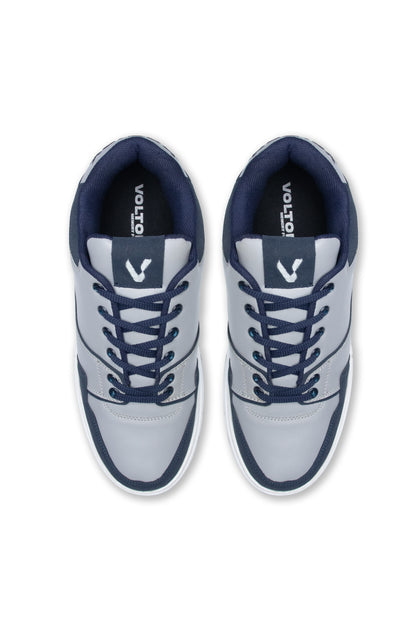 Pair of gray sneakers with navy accents on a white background