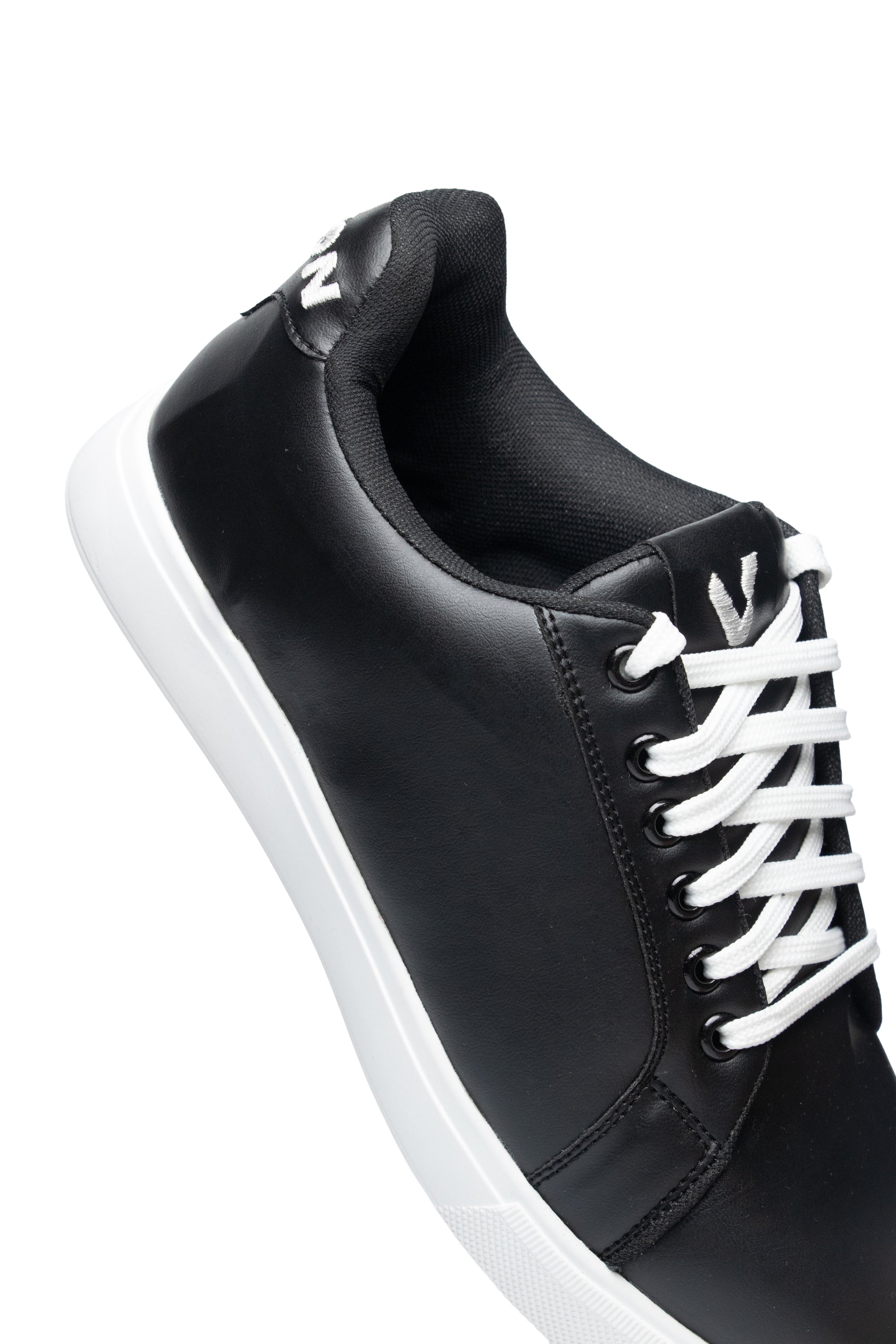 Black sneaker with white laces on a white background
