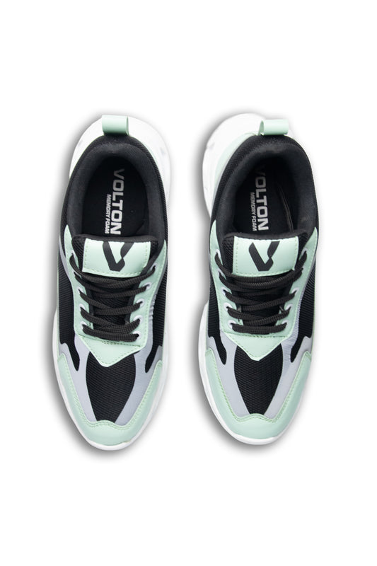 Pair of black and light green sneakers with 'Volution' branding on a white background