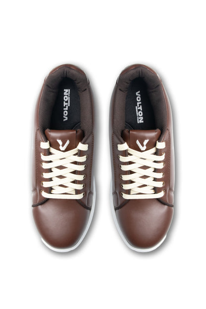 Brown sneakers with white laces on a white background